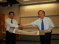 Prof. Jia Yimin (left), Vice President of Jinan University presents a souvenir to Prof. Jack Cheng (right), Pro-Vice-Chancellor